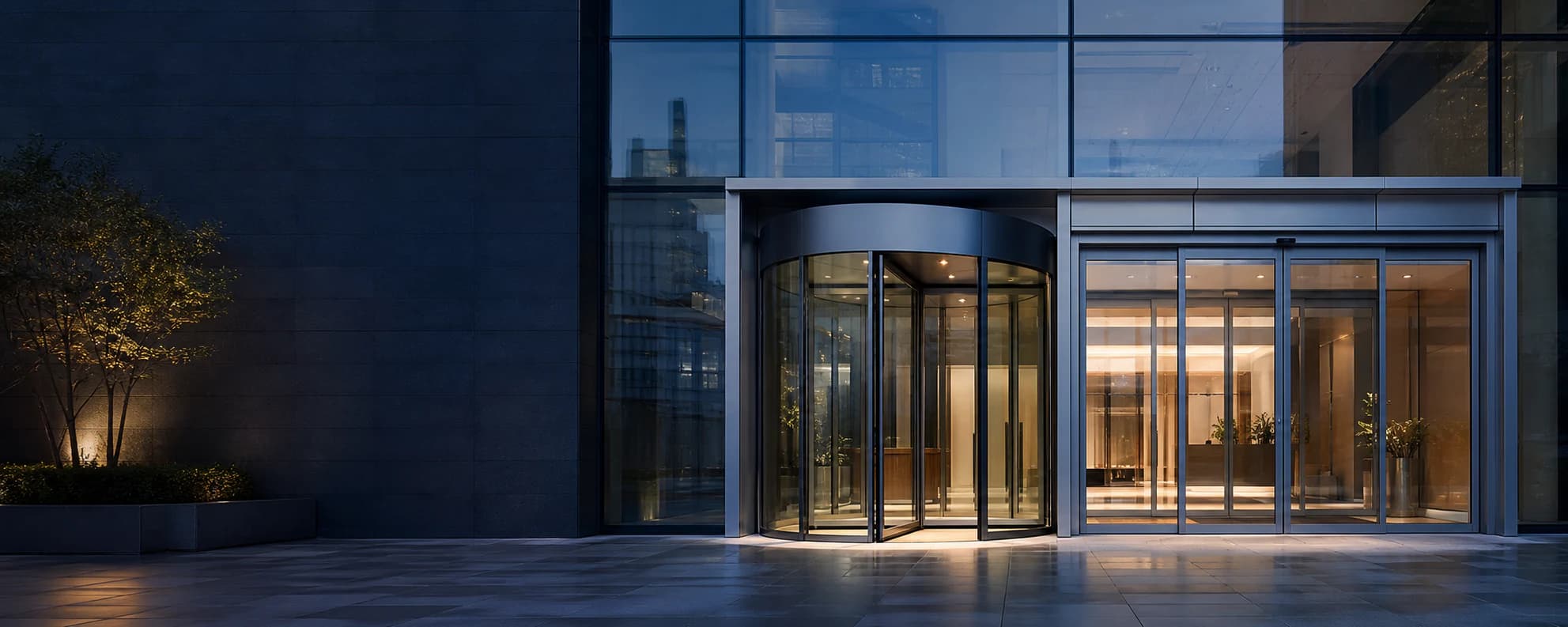 Automatic revolving and sliding glass doors at a modern commercial entrance