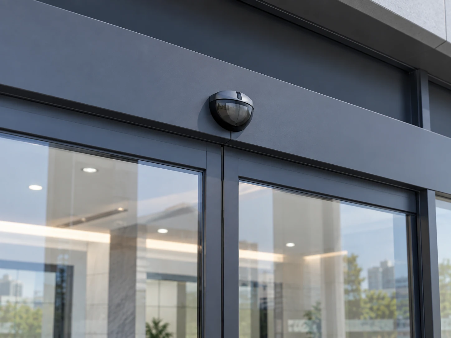 Header cover and overhead sensor above framed sliding glass door leaves