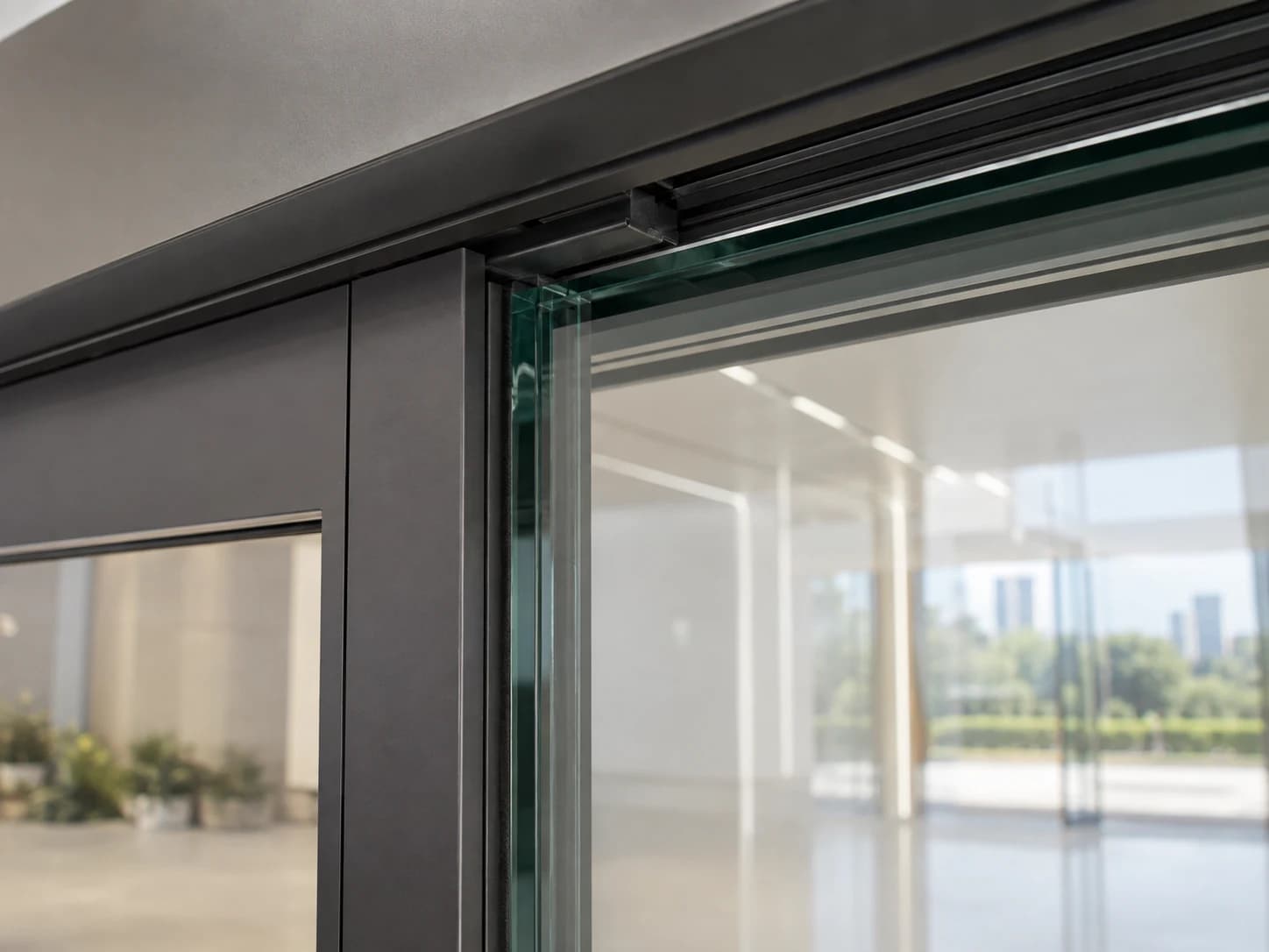 Close view of a dark aluminum profile meeting the glass edge