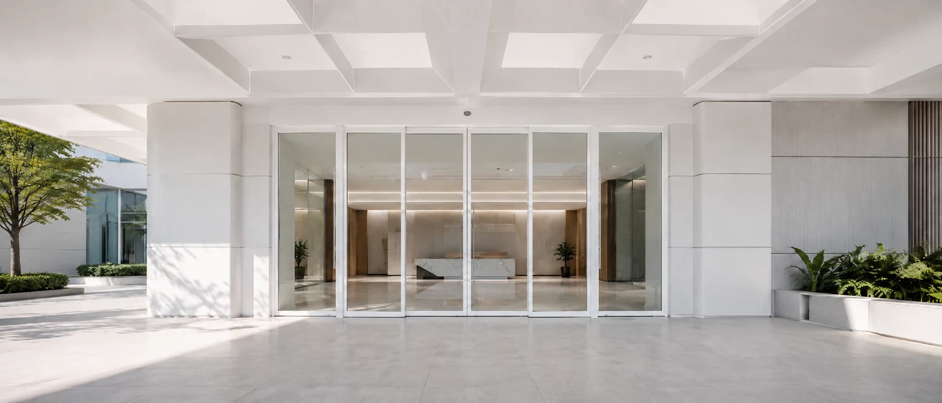 Automatic sliding glass door at a bright commercial building entrance