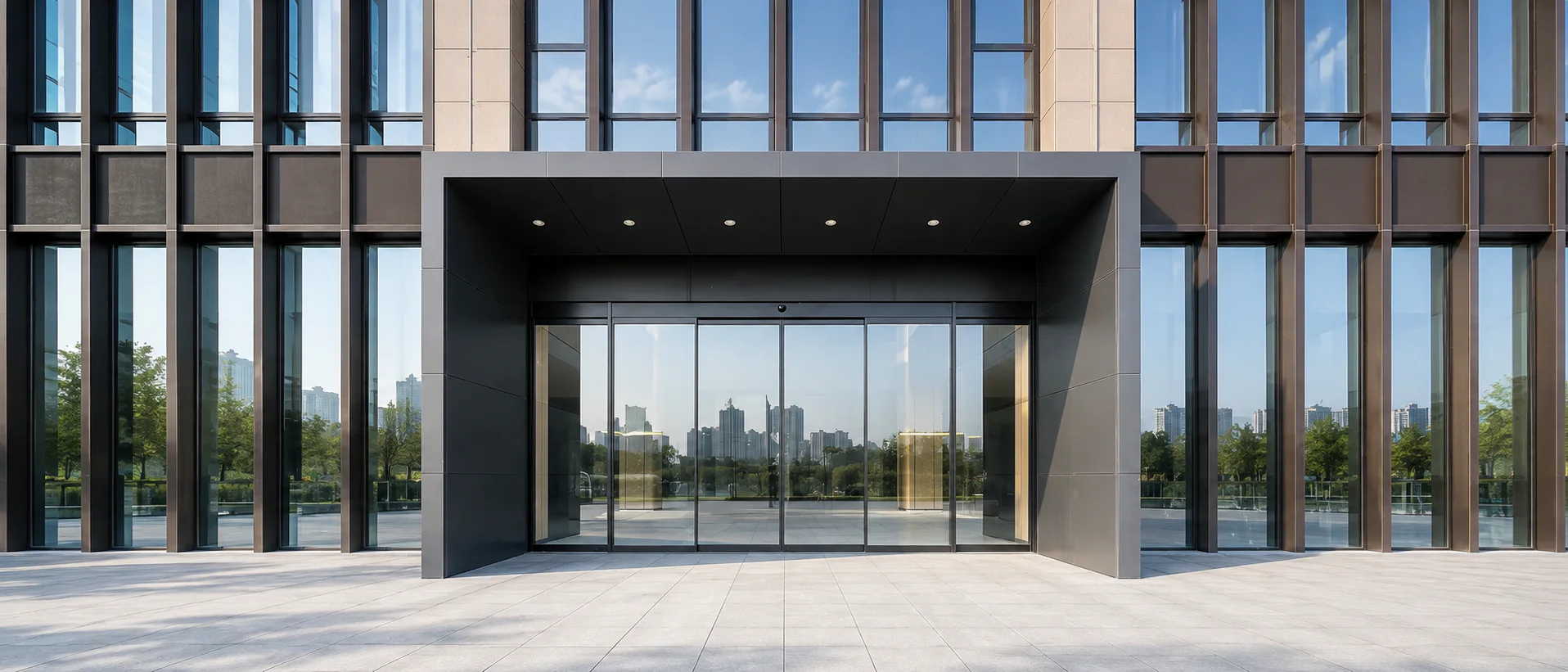 Automatic sliding glass entrance across a modern office building facade