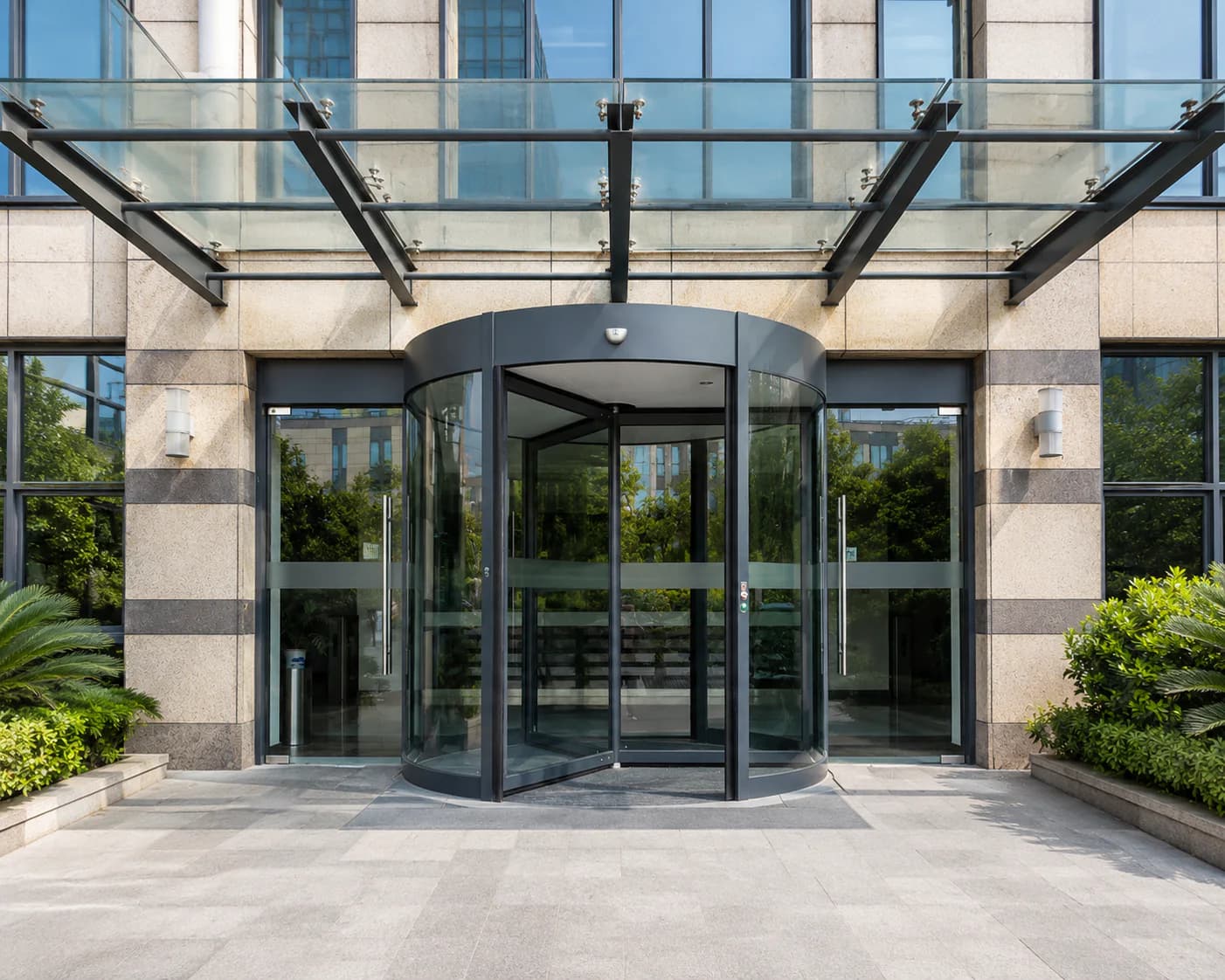Automatic revolving glass door at an office building entrance