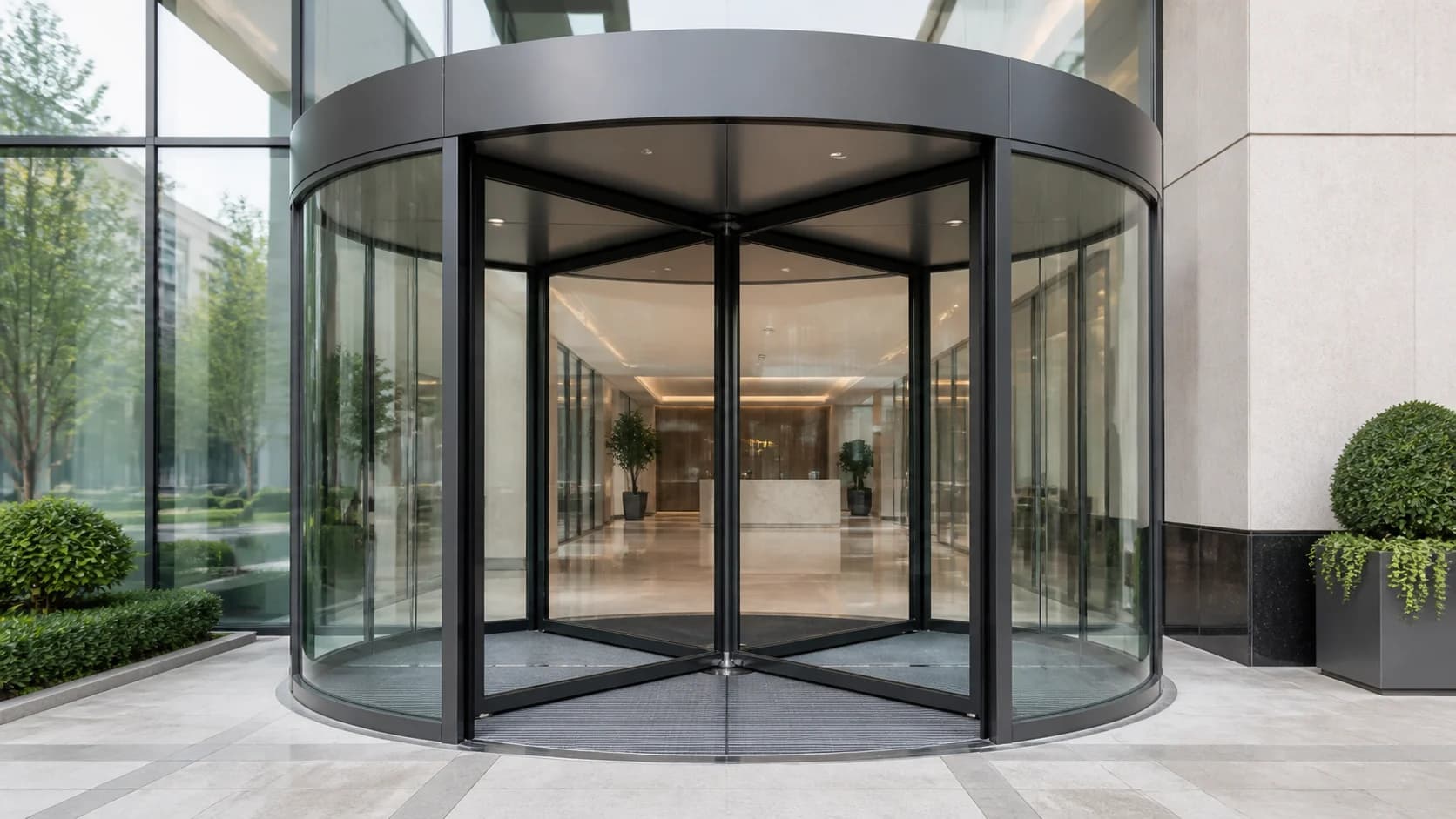Automatic revolving glass door fully visible at a modern commercial entrance
