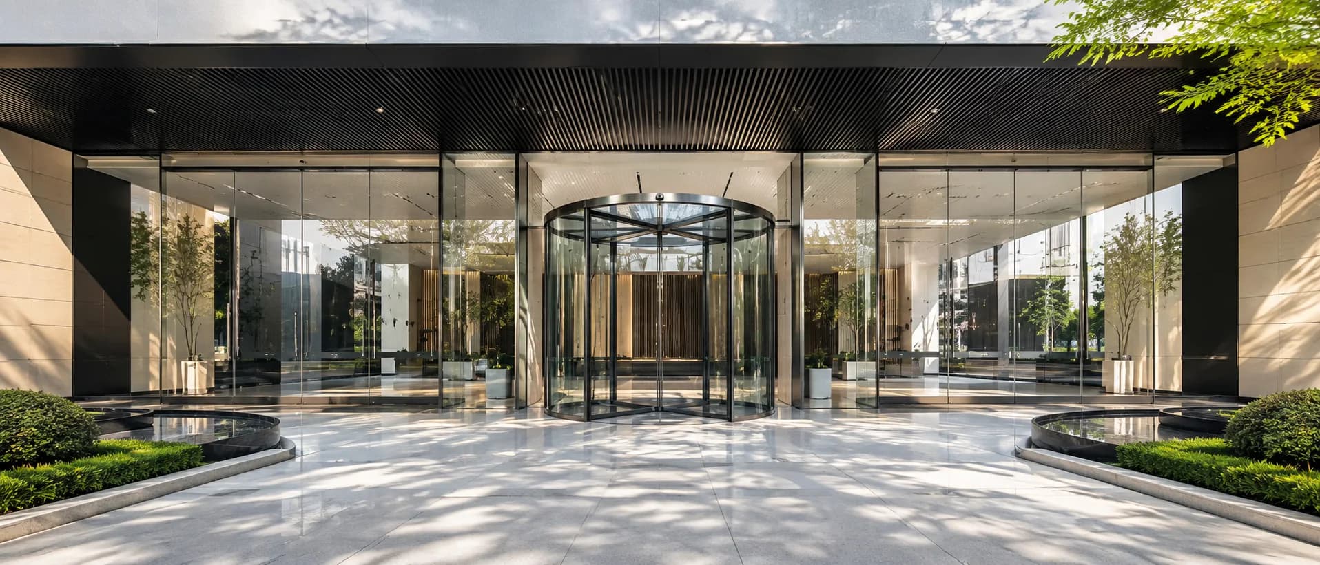 Automatic revolving glass door at a modern commercial entrance