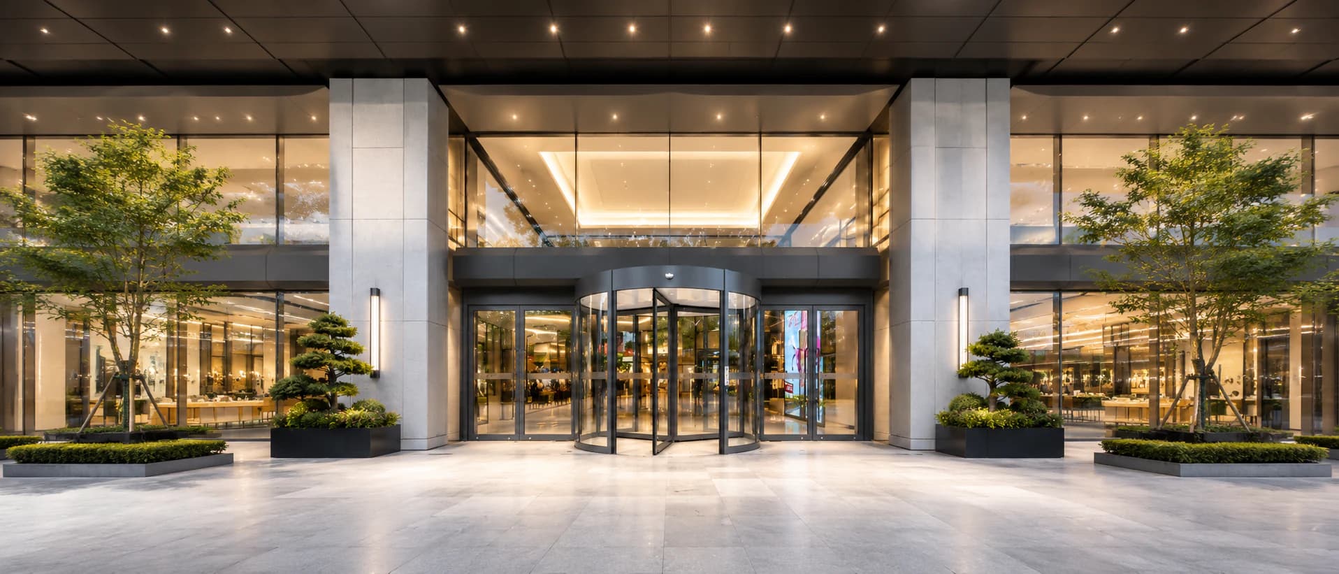 Automatic revolving glass door at a modern commercial building entrance