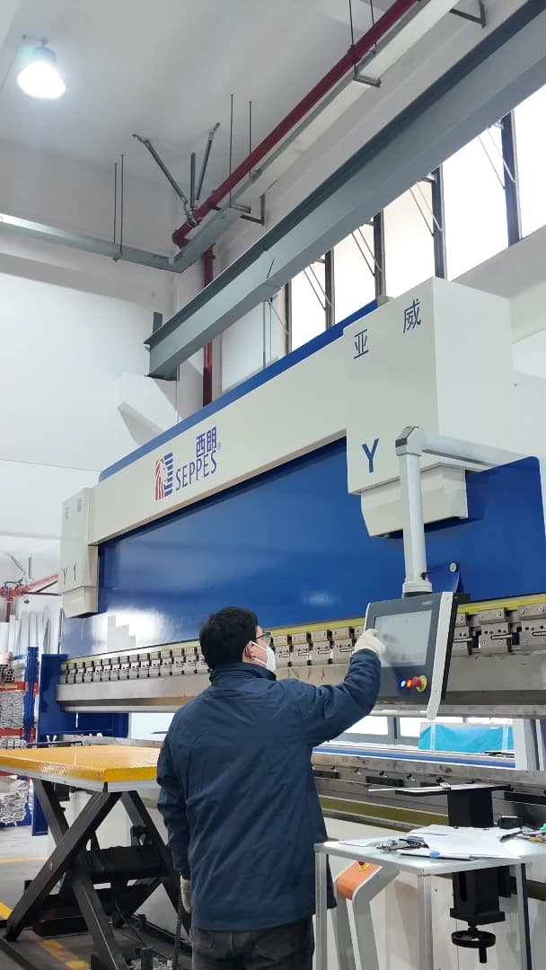 SEPPES factory operator working at sheet-metal fabrication equipment